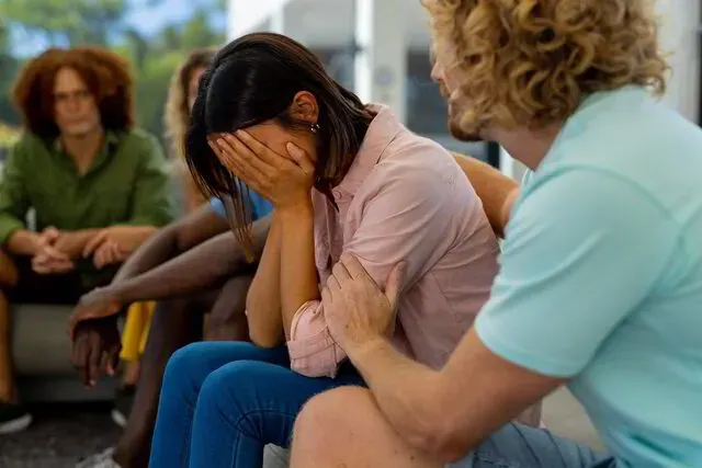 A comforting clasp of hands representing one-on-one grief coaching